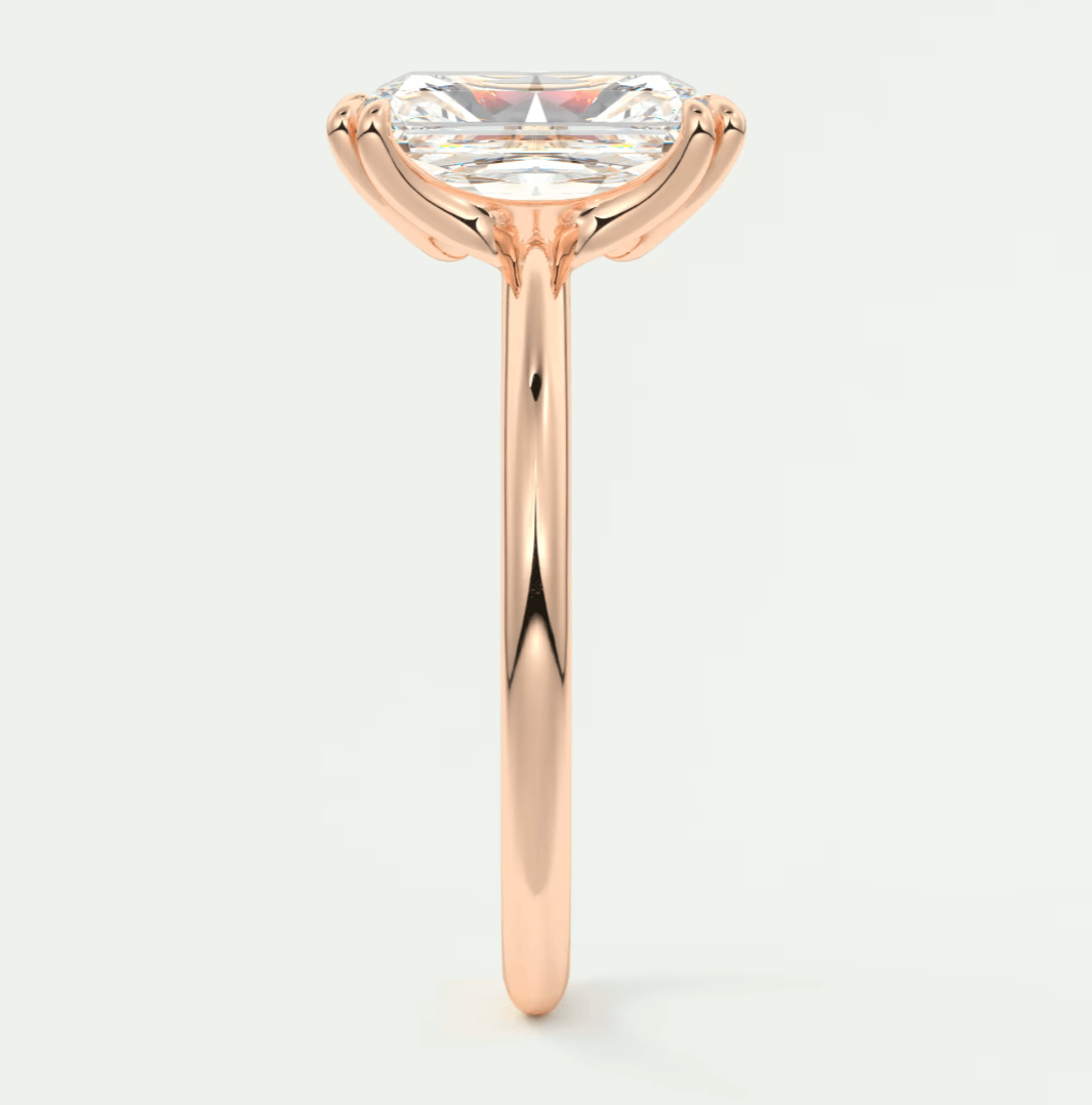 Rose gold engagement ring with a marquise-cut diamond.