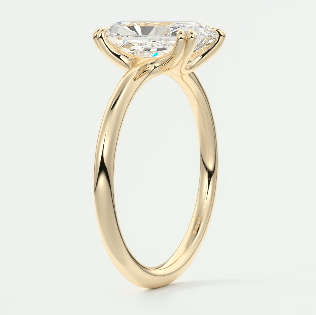 18k yellow gold solitaire engagement ring with a cushion-cut diamond.