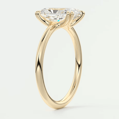 18k yellow gold solitaire engagement ring with a cushion-cut diamond.
