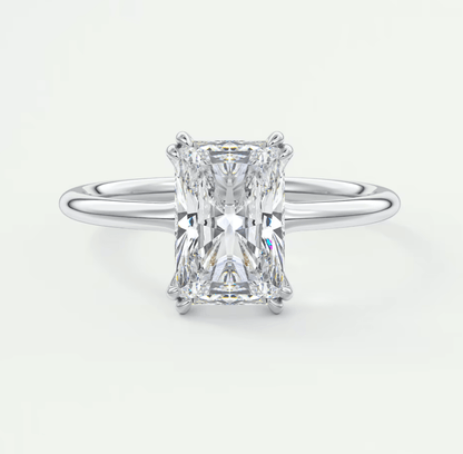 18-karat white gold engagement ring with a radiant cut diamond.