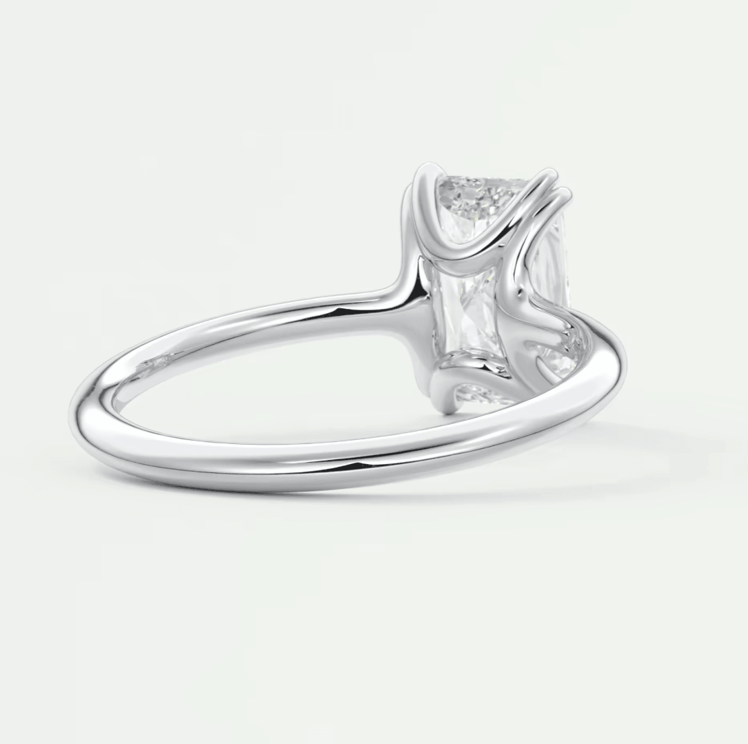 White gold princess cut diamond engagement ring with baguette side stones and a sleek band.