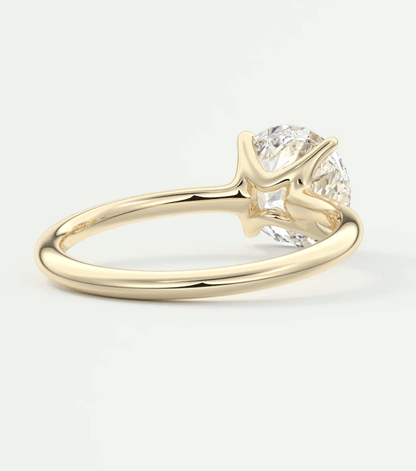 18k yellow gold solitaire diamond engagement ring with a round brilliant cut gemstone.