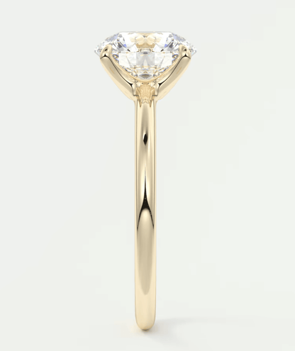 18-karat yellow gold solitaire engagement ring with a round diamond.