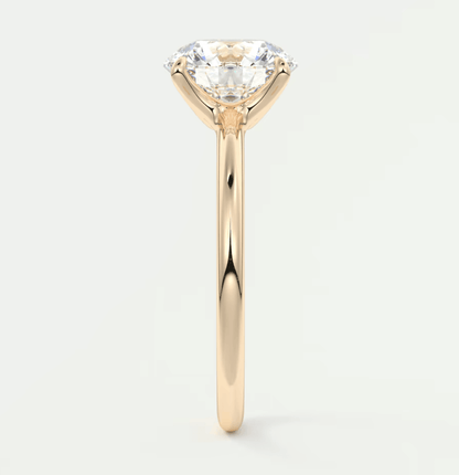 18k gold solitaire diamond engagement ring with a round brilliant cut gem.