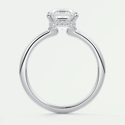 18k white gold emerald cut diamond engagement ring with a halo of smaller diamonds.