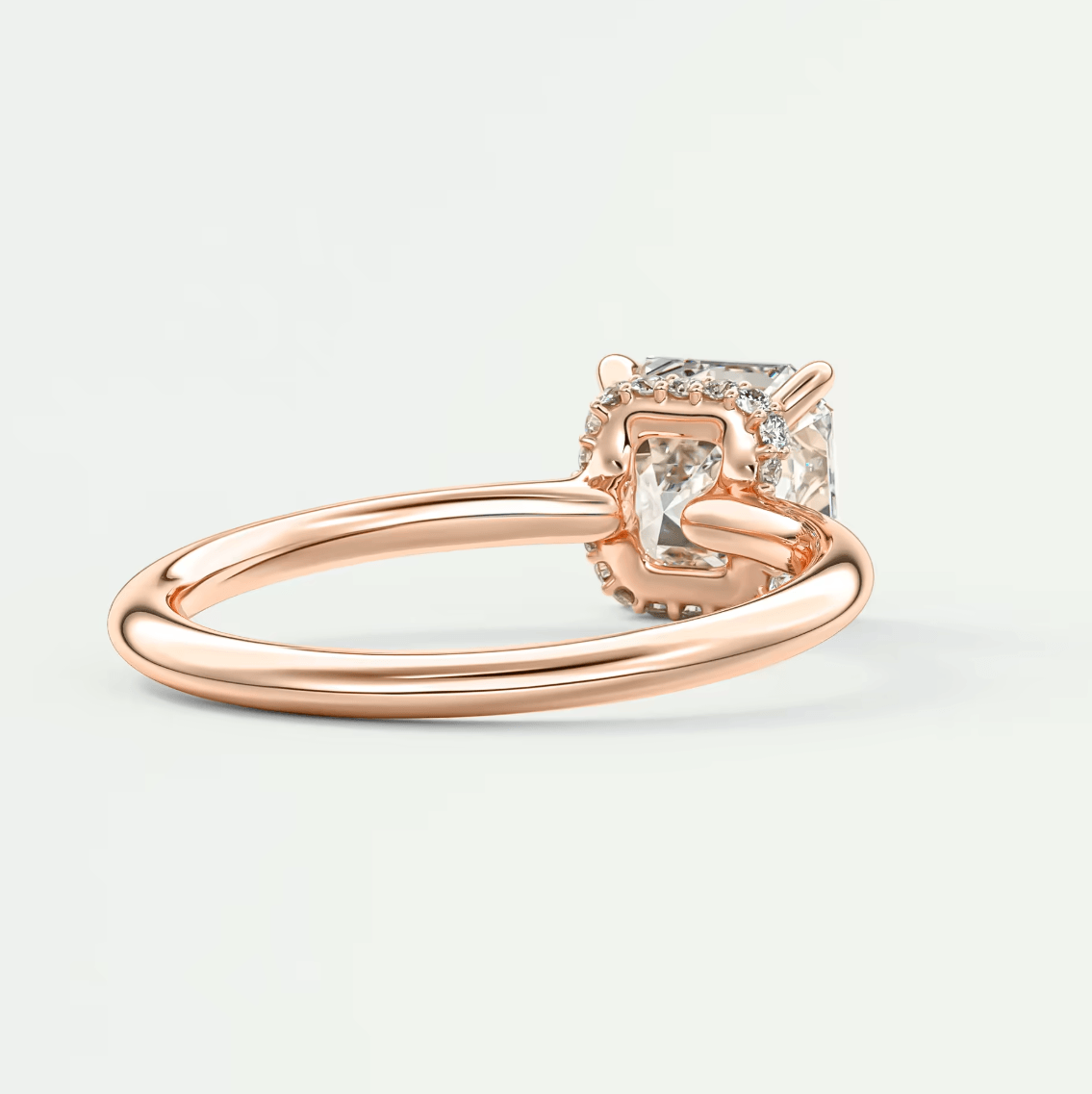 Rose gold princess cut diamond engagement ring with a four-prong setting and delicate band.