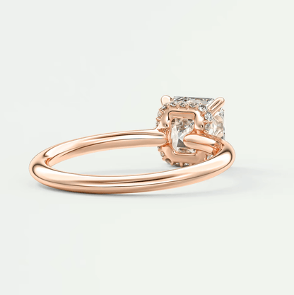 Rose gold princess cut diamond engagement ring with a four-prong setting and delicate band.