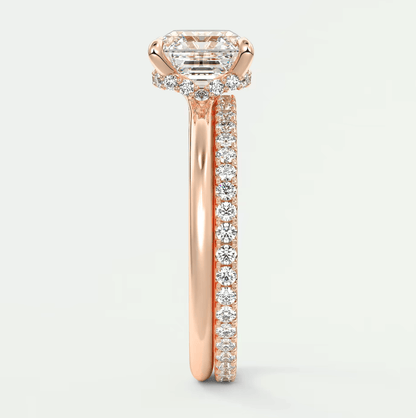 18-karat rose gold engagement ring with a princess-cut diamond center stone and pavé-set diamonds on the band.