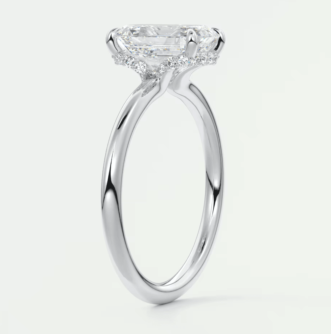 18-karat white gold engagement ring with a princess-cut diamond and halo of smaller diamonds.