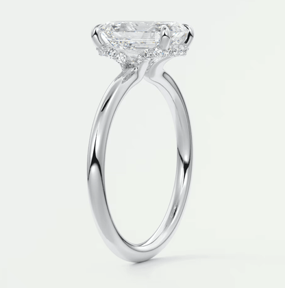 18-karat white gold engagement ring with a princess-cut diamond and halo of smaller diamonds.