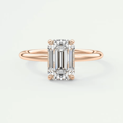 18-karat rose gold engagement ring with an emerald-cut diamond.