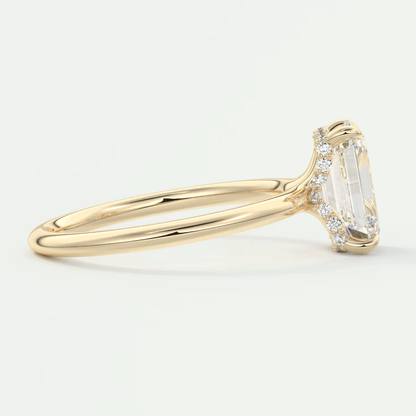 18k yellow gold emerald-cut diamond engagement ring with side diamonds.