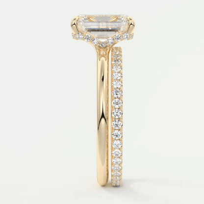 18k yellow gold engagement ring with a princess cut diamond and pavé set diamonds on the band.