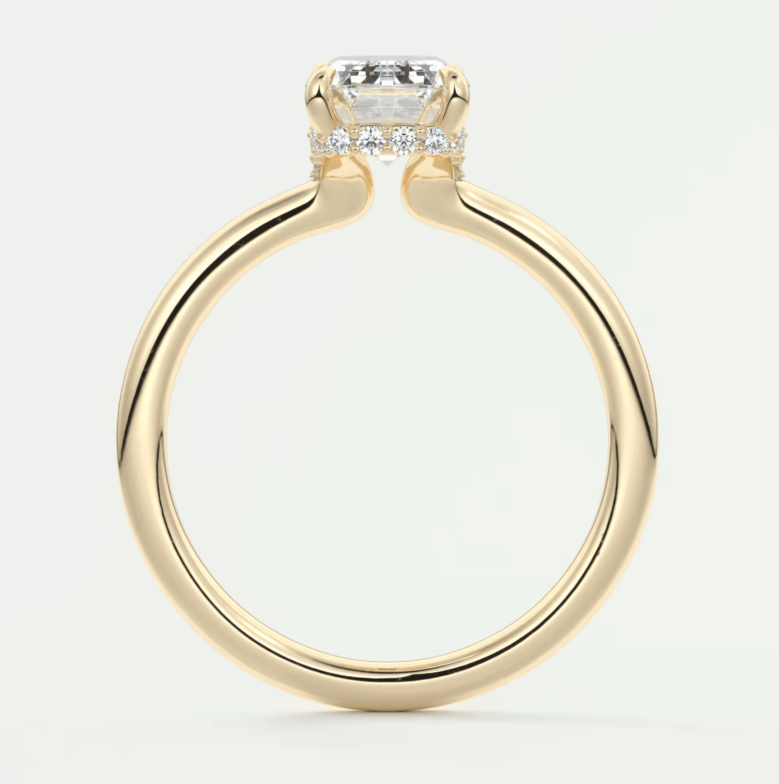 18k yellow gold engagement ring with a cushion-cut diamond and small diamonds on the band.
