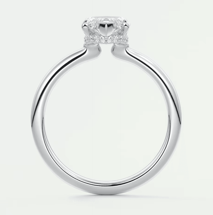 Silver diamond engagement ring with a cushion-cut center stone and two smaller side stones set in prongs.