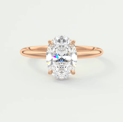 18k rose gold oval diamond engagement ring with a princess cut center stone.