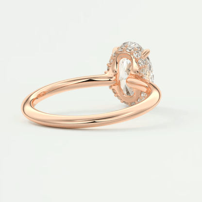 Rose gold diamond engagement ring with an oval-cut center stone and a halo of smaller diamonds.