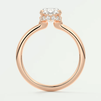 Rose gold engagement ring with a cushion-cut diamond and smaller diamonds set in the band, featuring an elegant halo design.