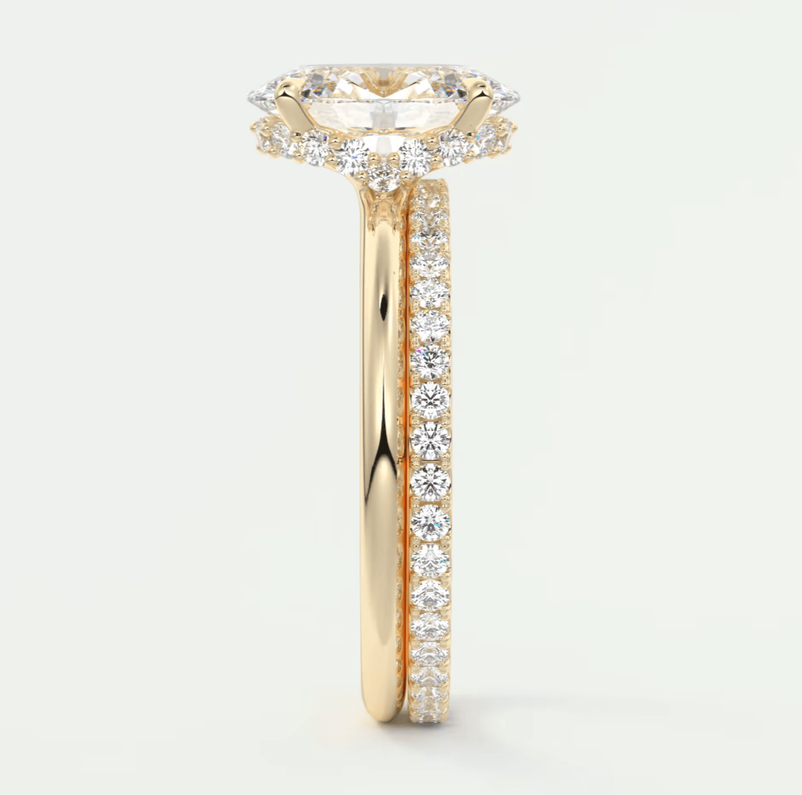 18k yellow gold diamond engagement ring with a marquise-cut center stone and channel-set diamonds on the band.