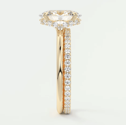 18k yellow gold diamond engagement ring with a marquise-cut center stone and channel-set diamonds on the band.