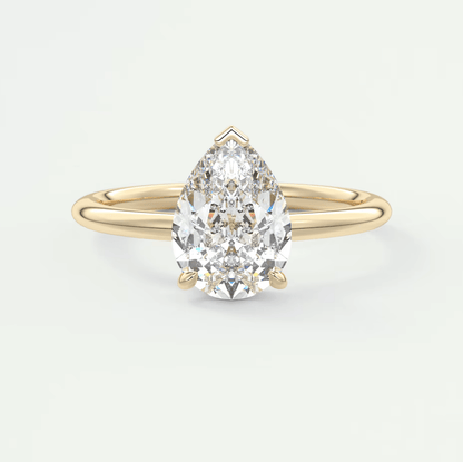 18k yellow gold pear-shaped diamond engagement ring.