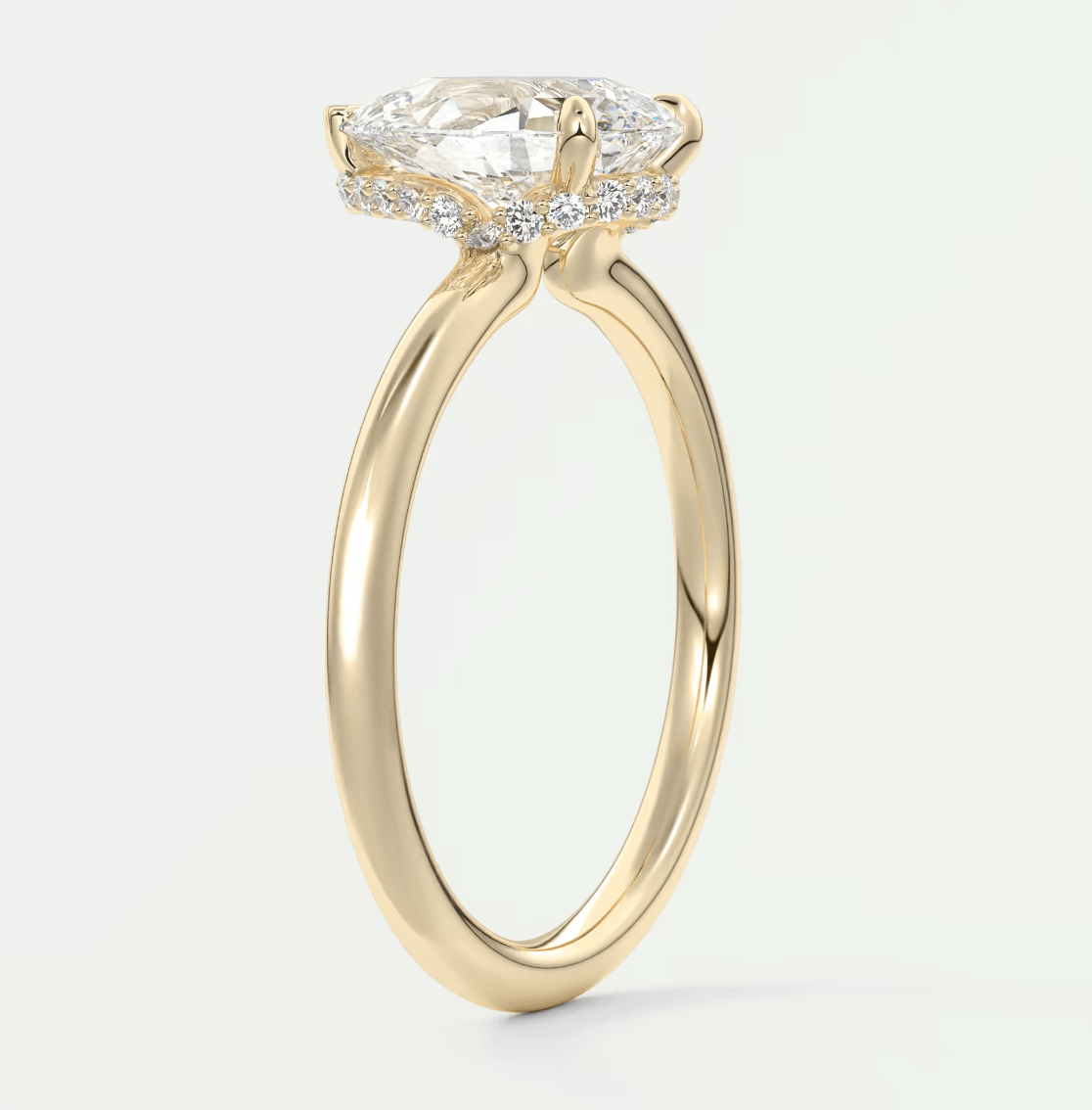 18k yellow gold engagement ring with a marquise-cut diamond and small round diamonds set in the band.