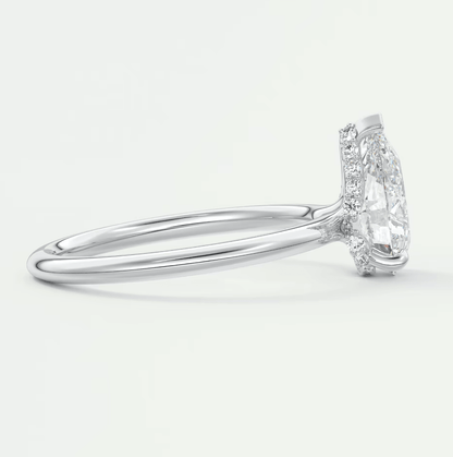 18-karat white gold engagement ring with a marquise-cut diamond and halo of smaller diamonds.