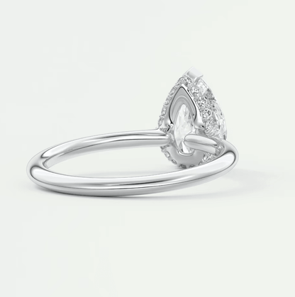 Pear-shaped diamond engagement ring with halo of smaller diamonds, white gold or platinum.
