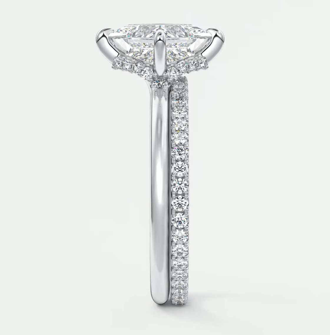 18k white gold diamond engagement ring with a marquise-cut center stone and pavé set diamonds on the band.