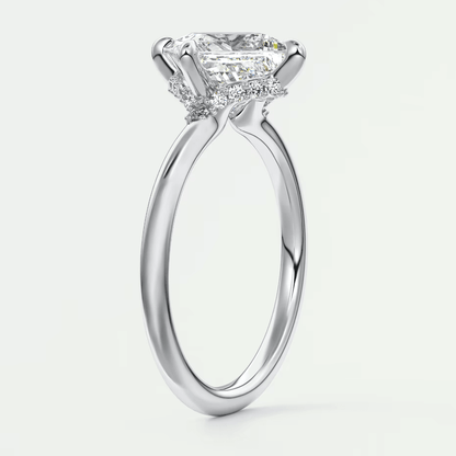 Princess cut diamond engagement ring with white gold band and diamonds on the sides.