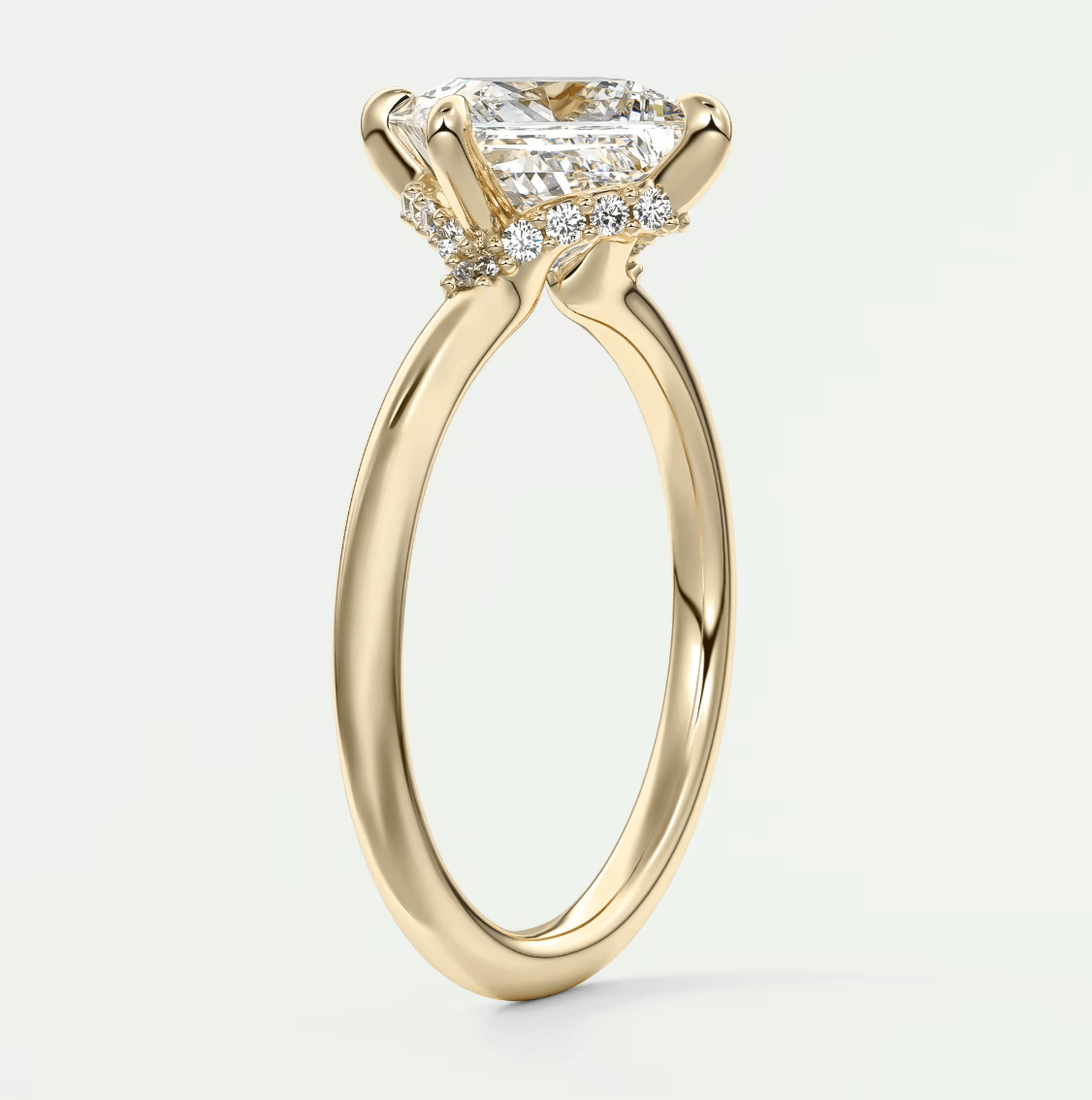18k yellow gold engagement ring with a princess cut diamond and halo design.