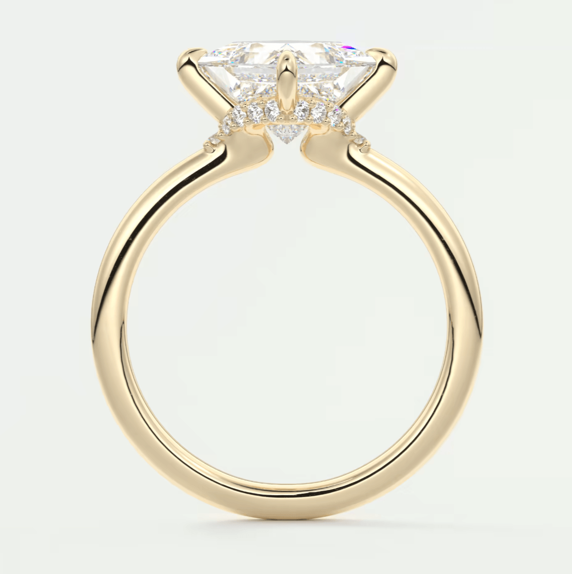 18k yellow gold engagement ring with a princess cut diamond and smaller diamonds on the band.