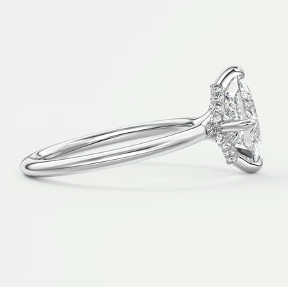 18k white gold engagement ring with marquise-cut diamond.