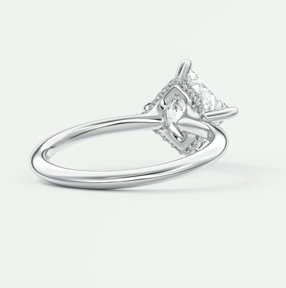 White gold diamond engagement ring with a princess cut center stone and halo detailing.