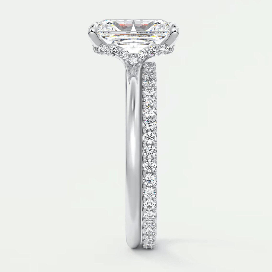 18-karat white gold engagement ring with a princess-cut diamond and pave-set diamonds on the band.