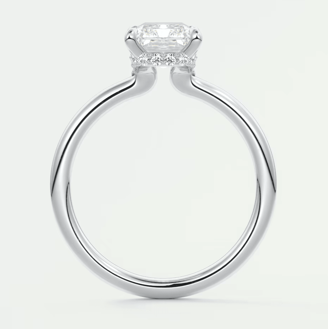 18k white gold cushion-cut diamond engagement ring with a halo of smaller diamonds.