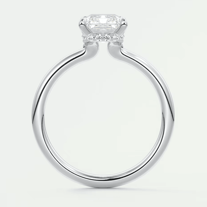 18k white gold cushion-cut diamond engagement ring with a halo of smaller diamonds.