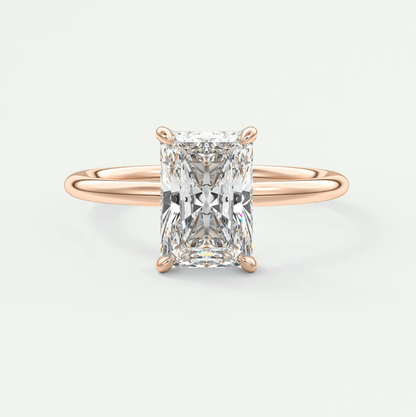 Rose gold diamond engagement ring with an emerald cut gemstone.