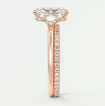 18-karat rose gold engagement ring with a princess-cut diamond and pave-set diamonds on the band.
