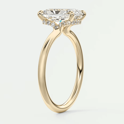 18k yellow gold engagement ring with a marquise-cut diamond and halo of smaller diamonds.