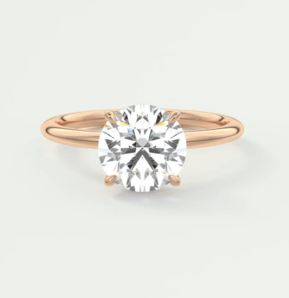 18-karat rose gold engagement ring with a round-cut diamond.