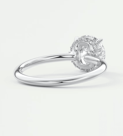 18-karat white gold diamond engagement ring with a round-cut center stone.