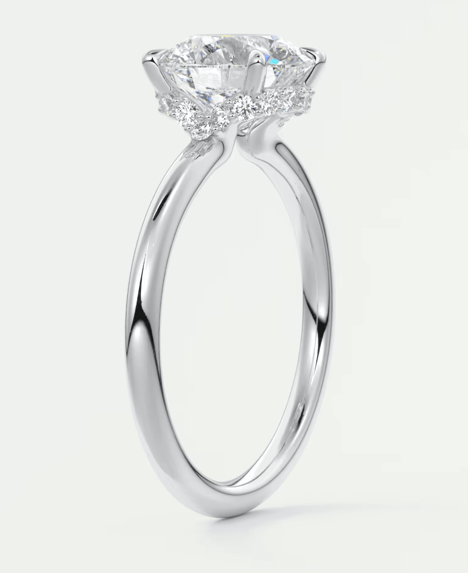 18-karat white gold engagement ring with a round diamond center stone.
