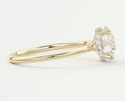 18k yellow gold diamond engagement ring with a marquise-cut center stone and halo of smaller diamonds.