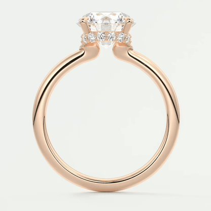 18-karat rose gold engagement ring with a cushion-cut diamond center stone and small diamonds on the band.