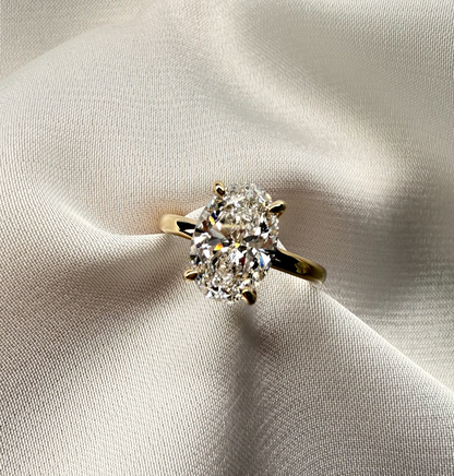 Diamond ring on a light fabric background