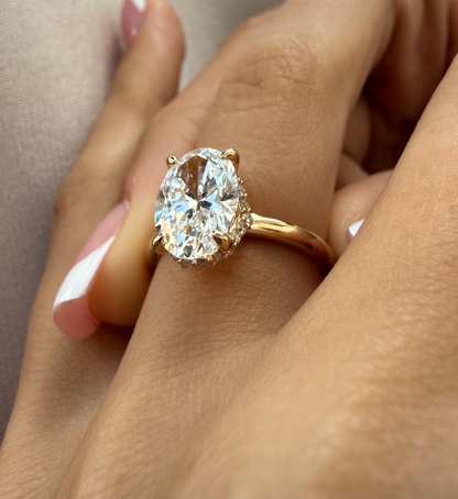 Gold ring with a large diamond on a hand