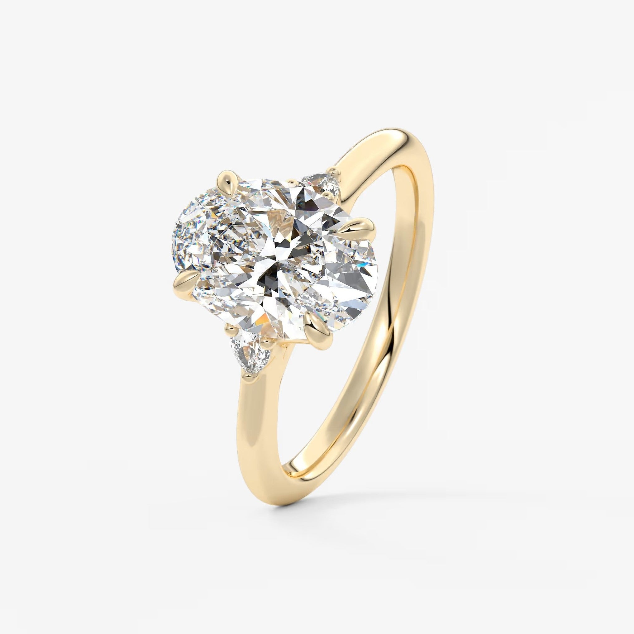 Cassia – oval trilogy with pear side stones