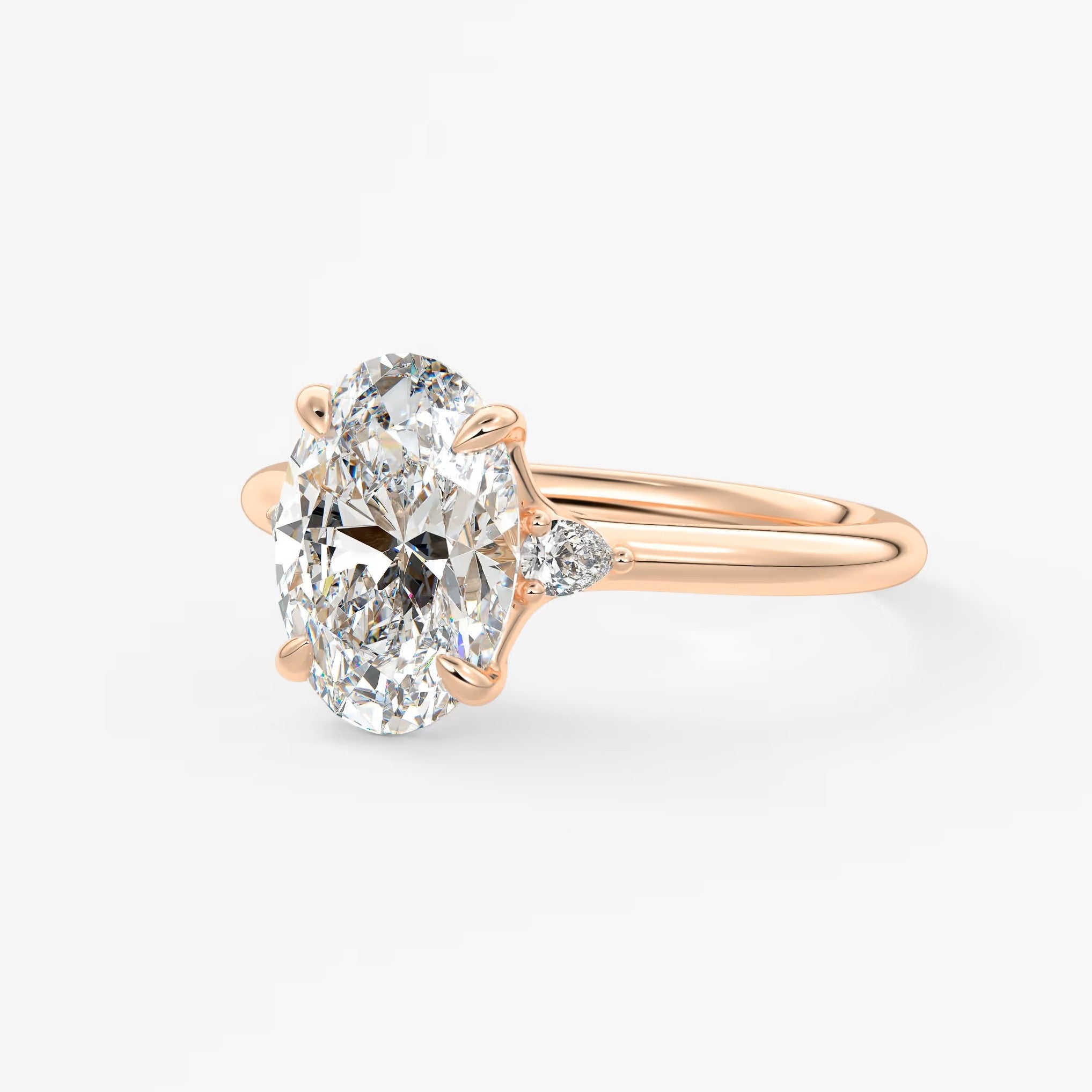 Cassia – oval trilogy with pear side stones