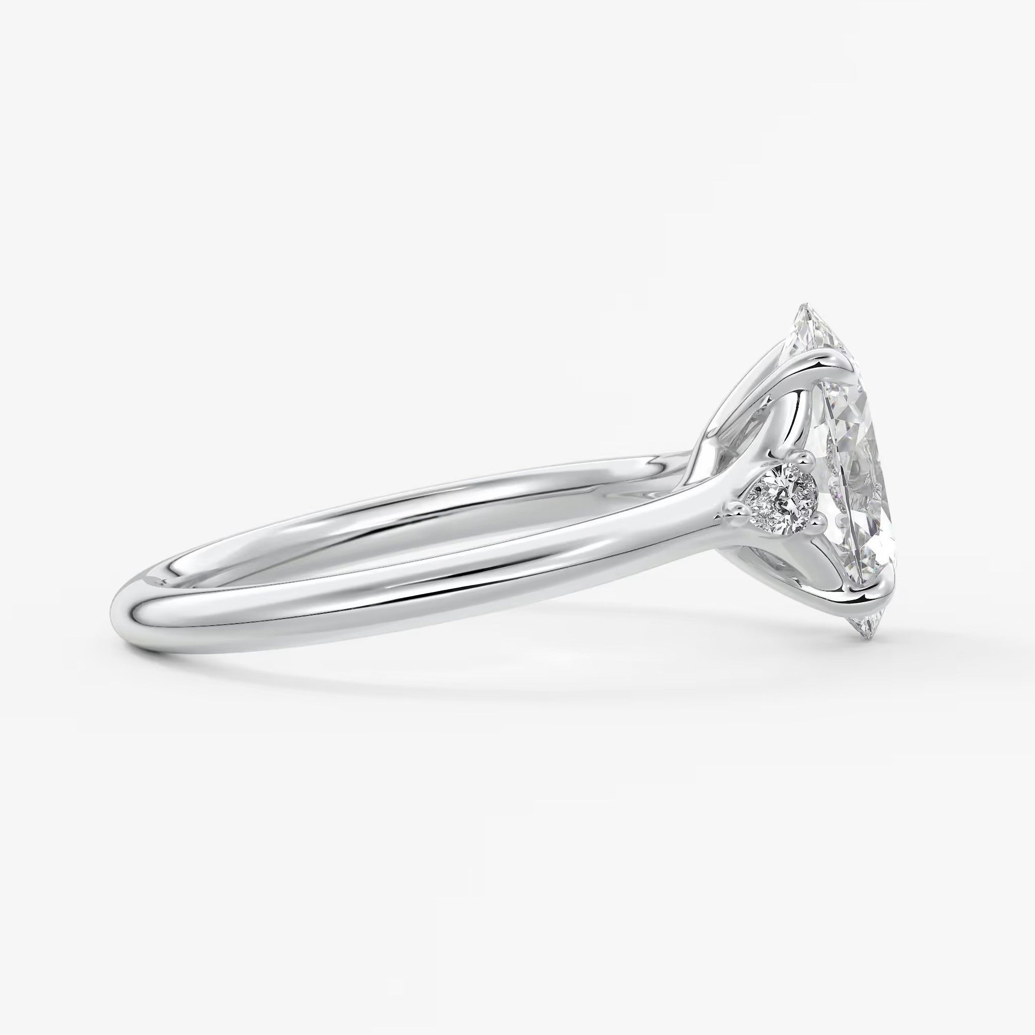 Cassia – oval trilogy with pear side stones